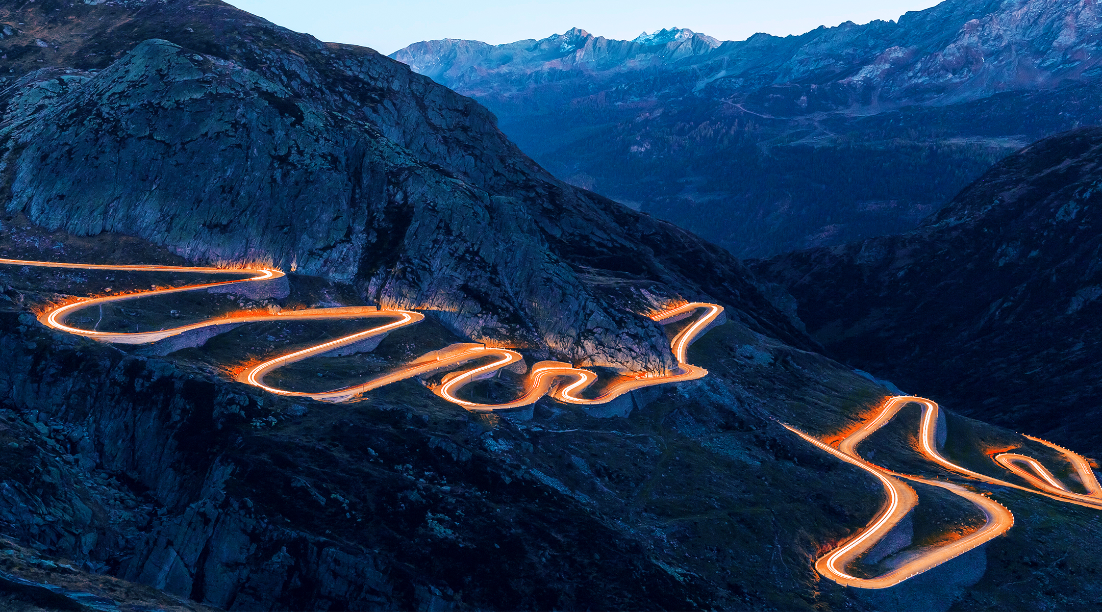 Long time exposure of cars driving along a serpentine road.