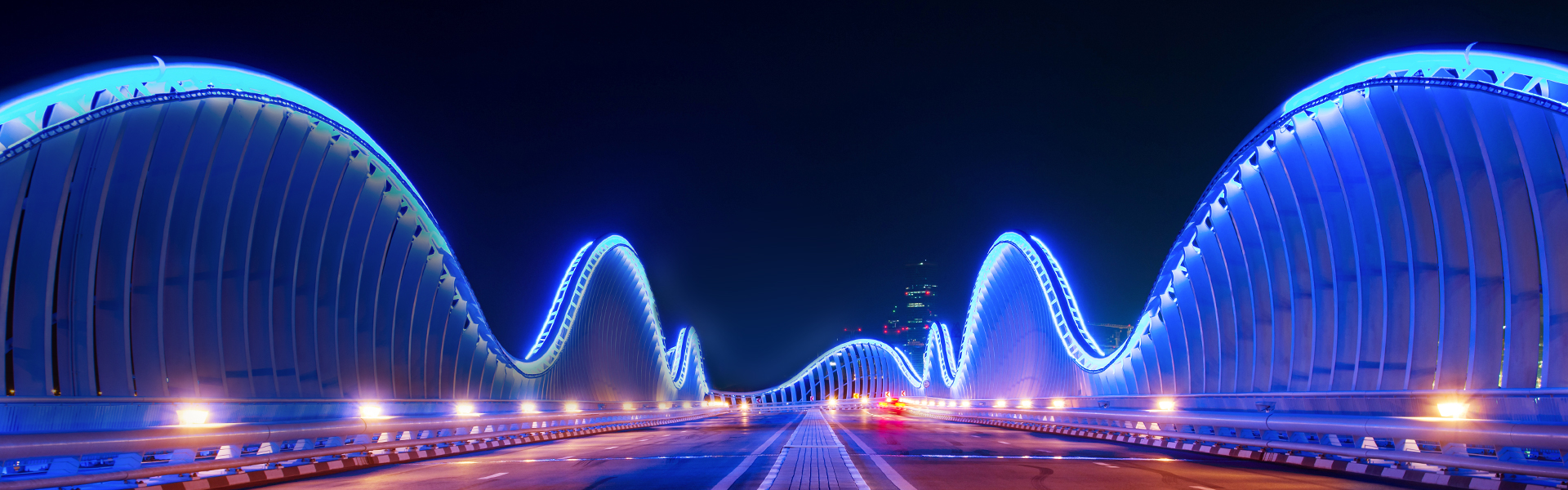 A nicely lighted Bridge in neon lights. 