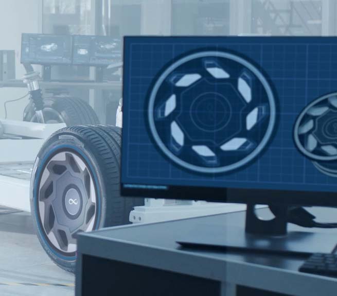 A screen in the foreground displays digital rim designs.