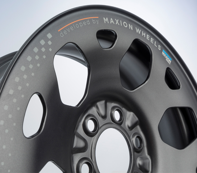 A metallic vehicle rim with a multi-hole design