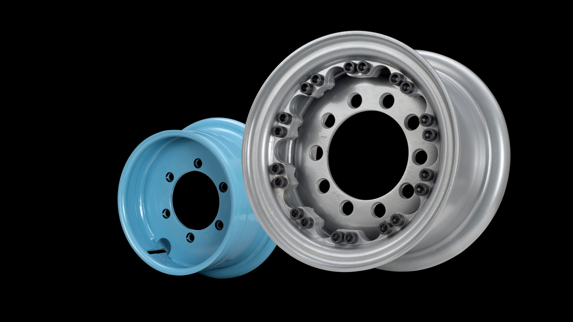 Three colored steel rims, the small on the left in light blue, the larger one in silver