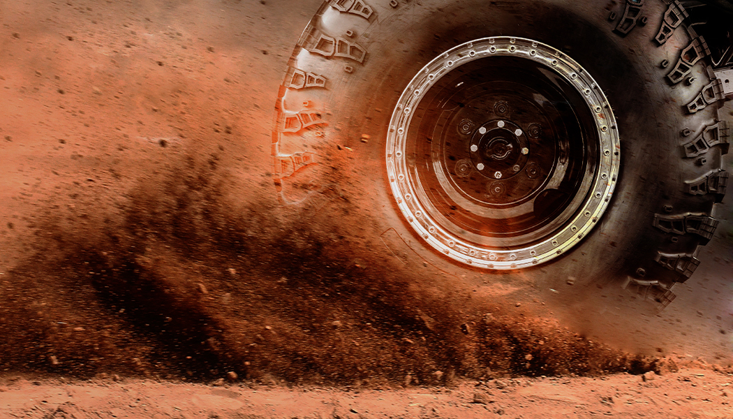 Image of a spinning wheel and flying soil.